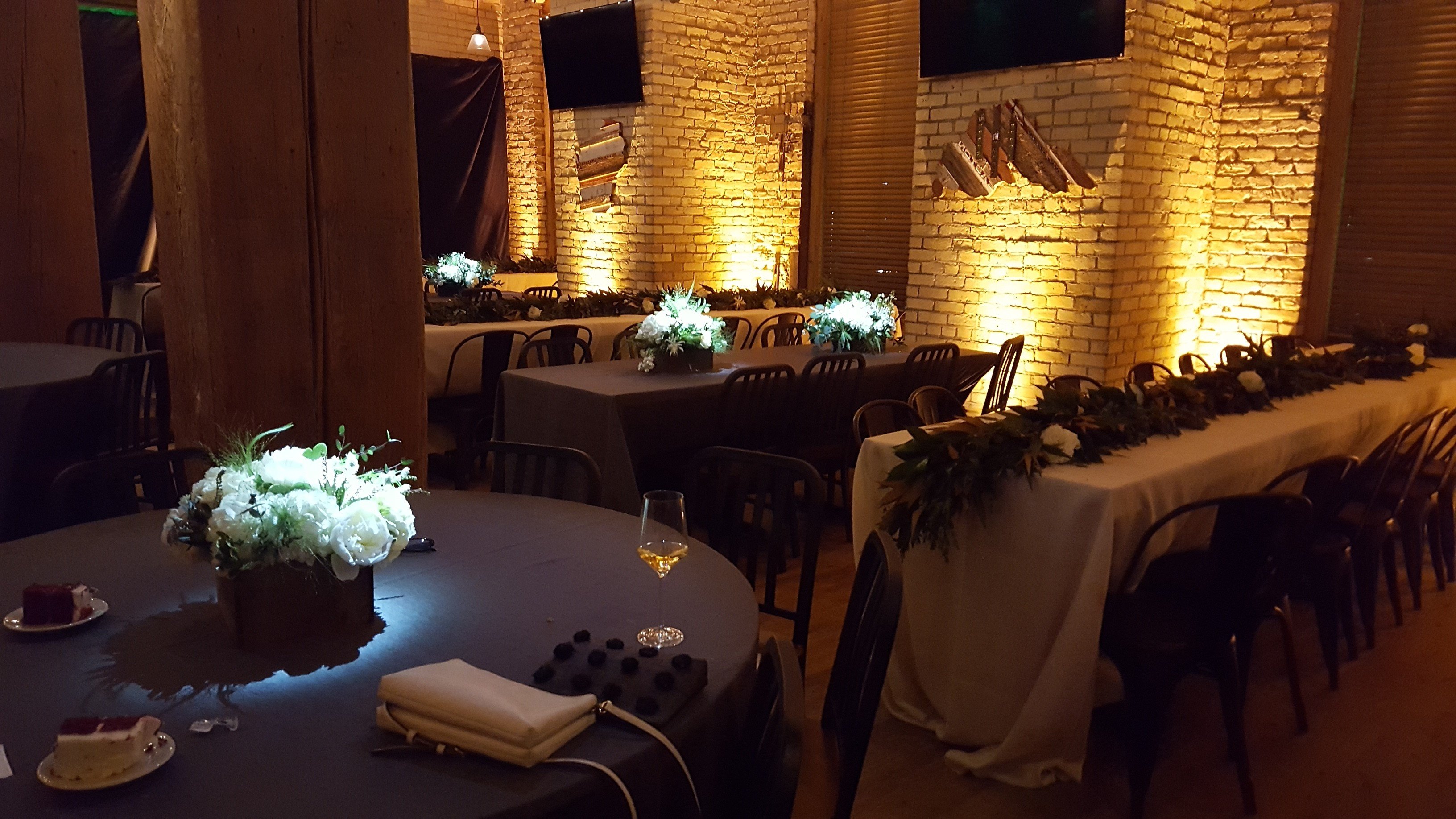 Hoops Brewery wedding. Up lighting in warm white withpin spots on flowers.