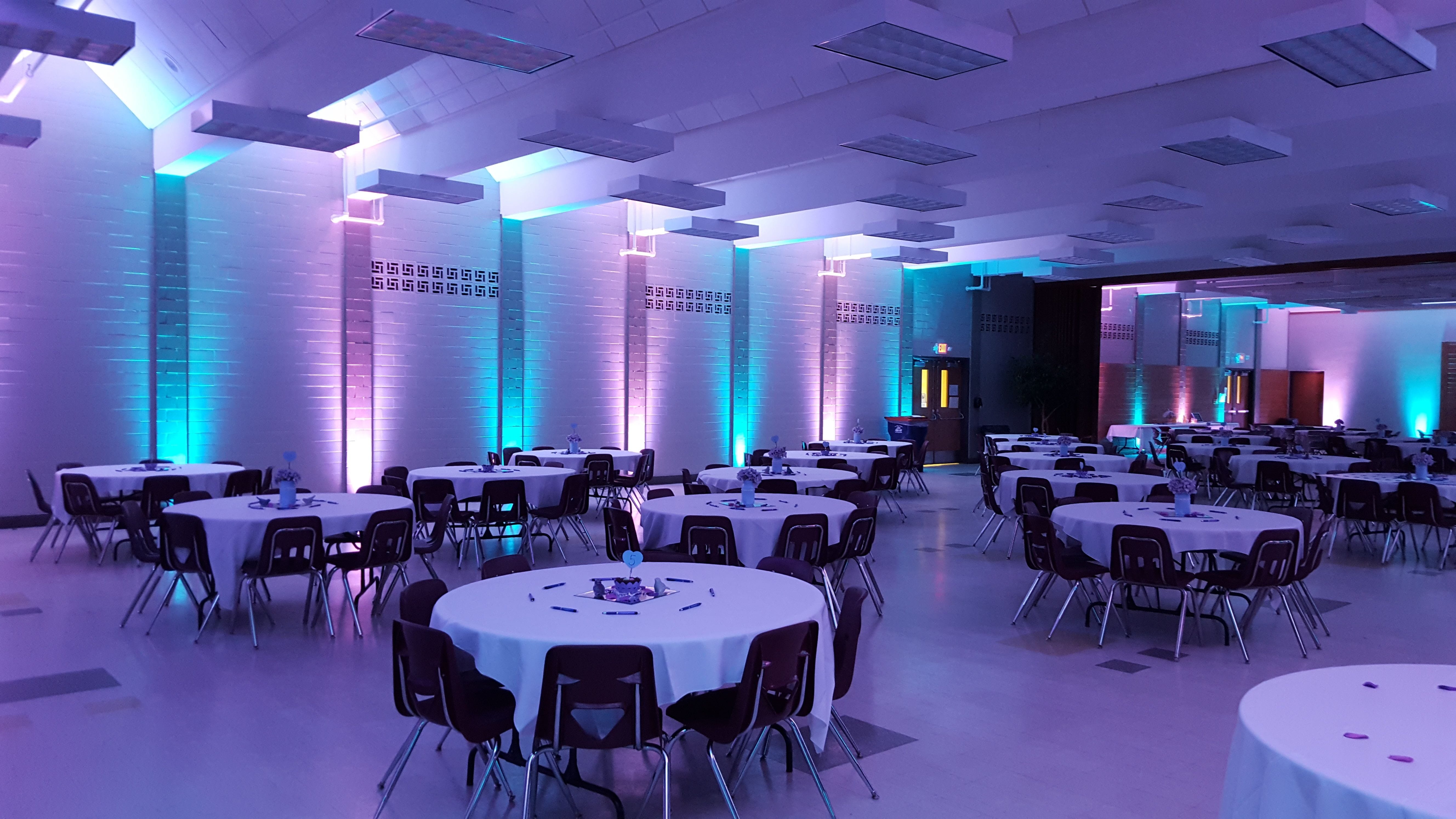 Wedding lighting at Marshall school. Up lighting in teal and lavender