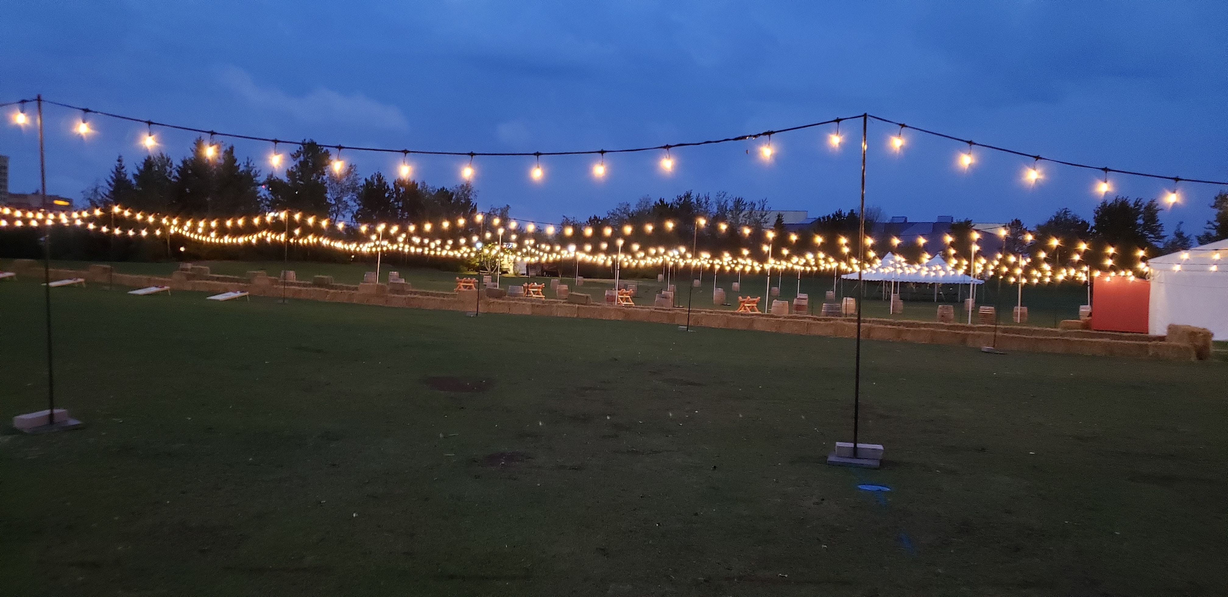 a large open field filled with outdoor bistro for the Duluth Oktoberfest.