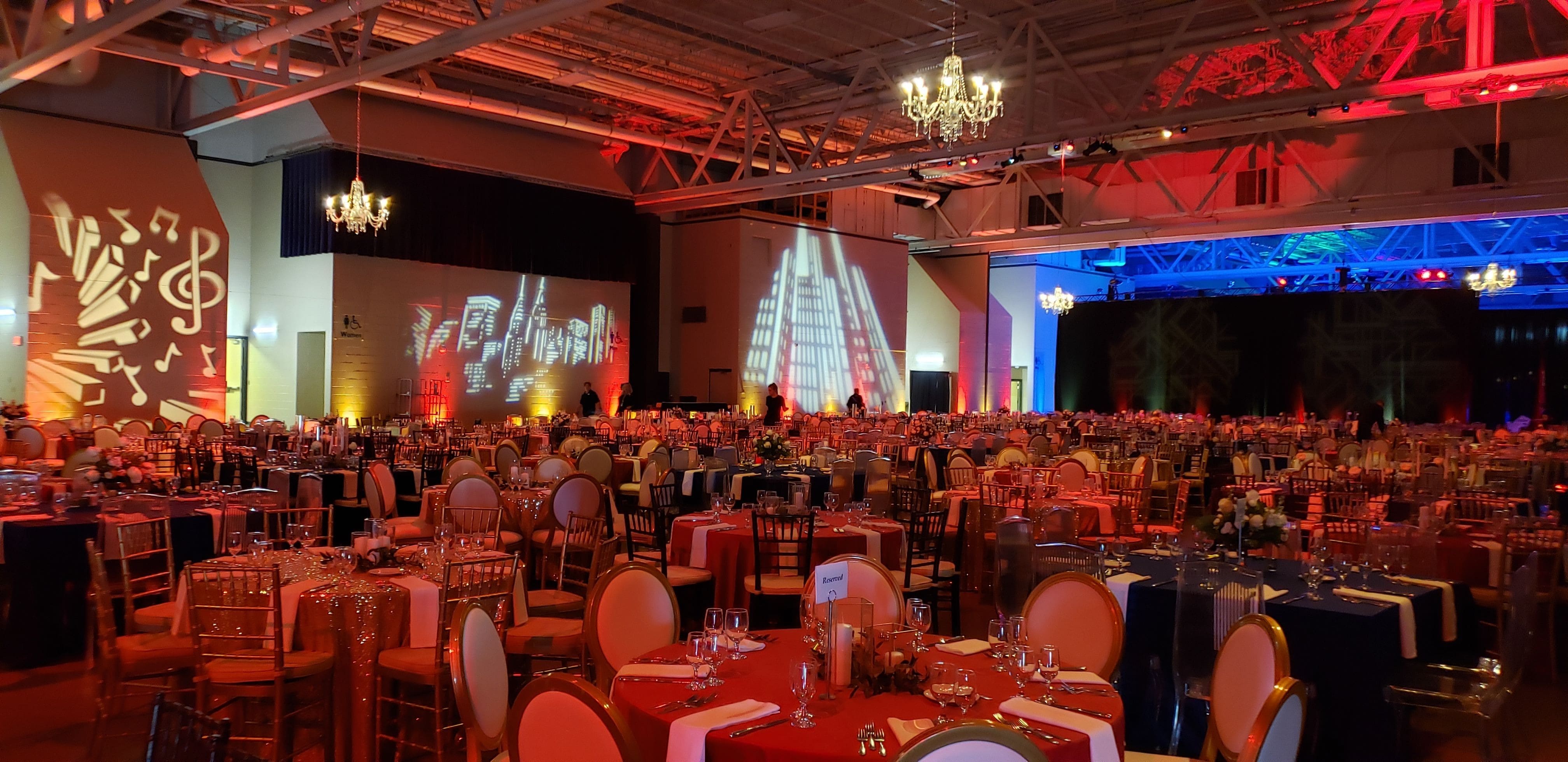 Event Lighting in pioneer Hall by Duluth Event Lighting. Red up lighting, gobos on the walls,chandeliers provided by Duluth Event Lighting.