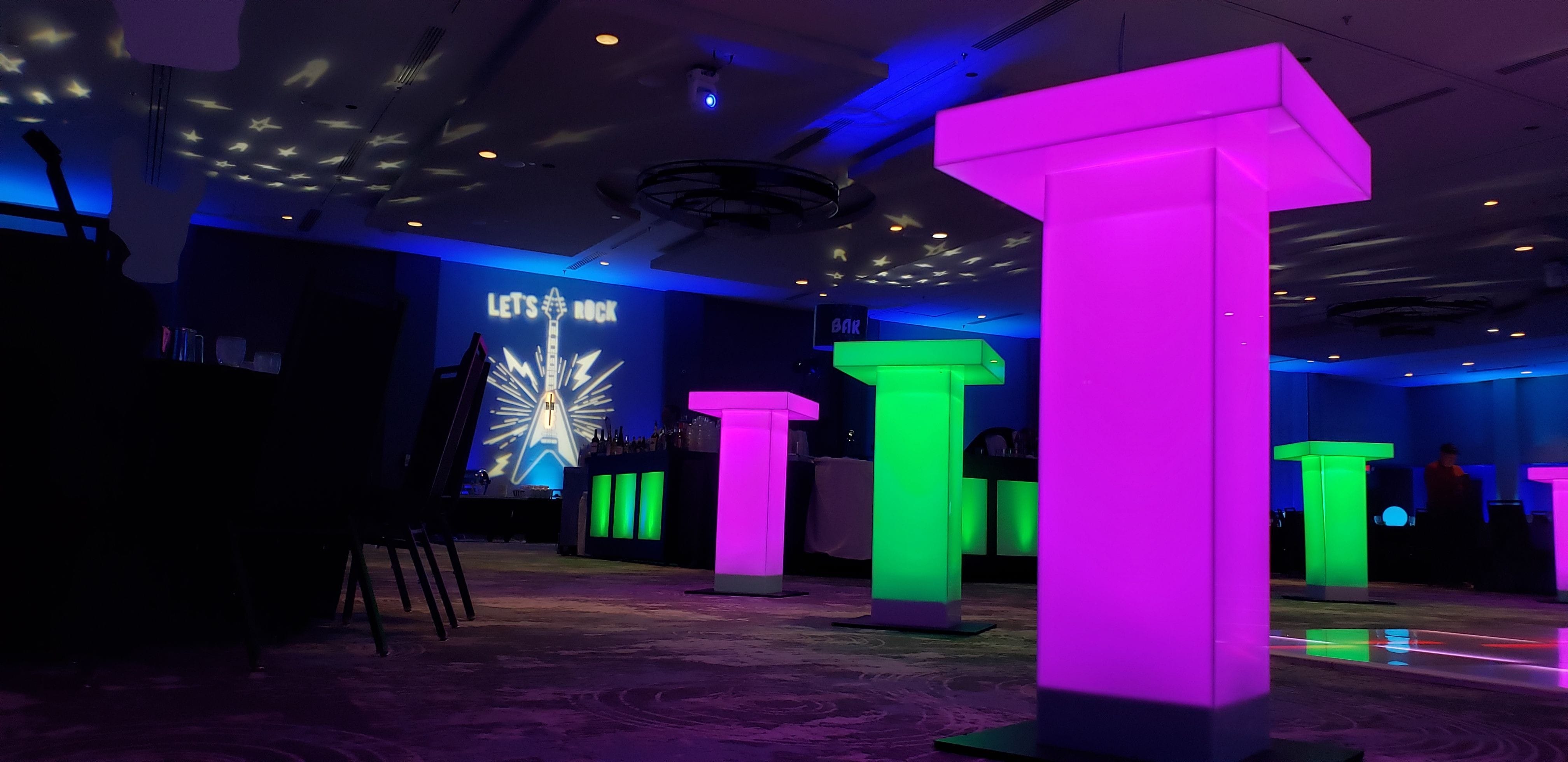 Let's Rock themed party with neon glowing cocktail tables.