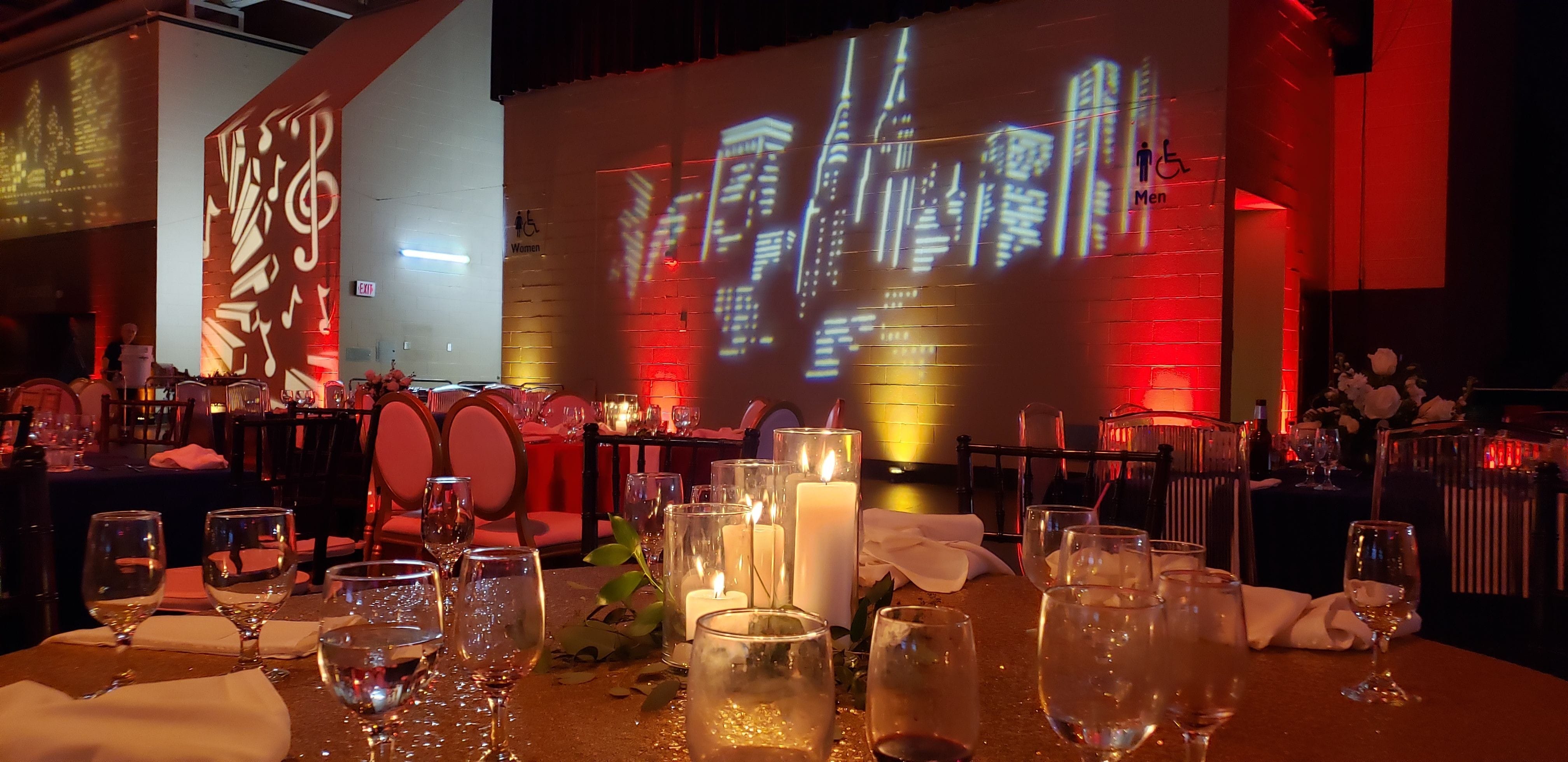 Event Lighting in pioneer Hall by Duluth Event Lighting. Red and gold up lighting, gobos on the walls,chandeliers provided by Duluth Event Lighting.