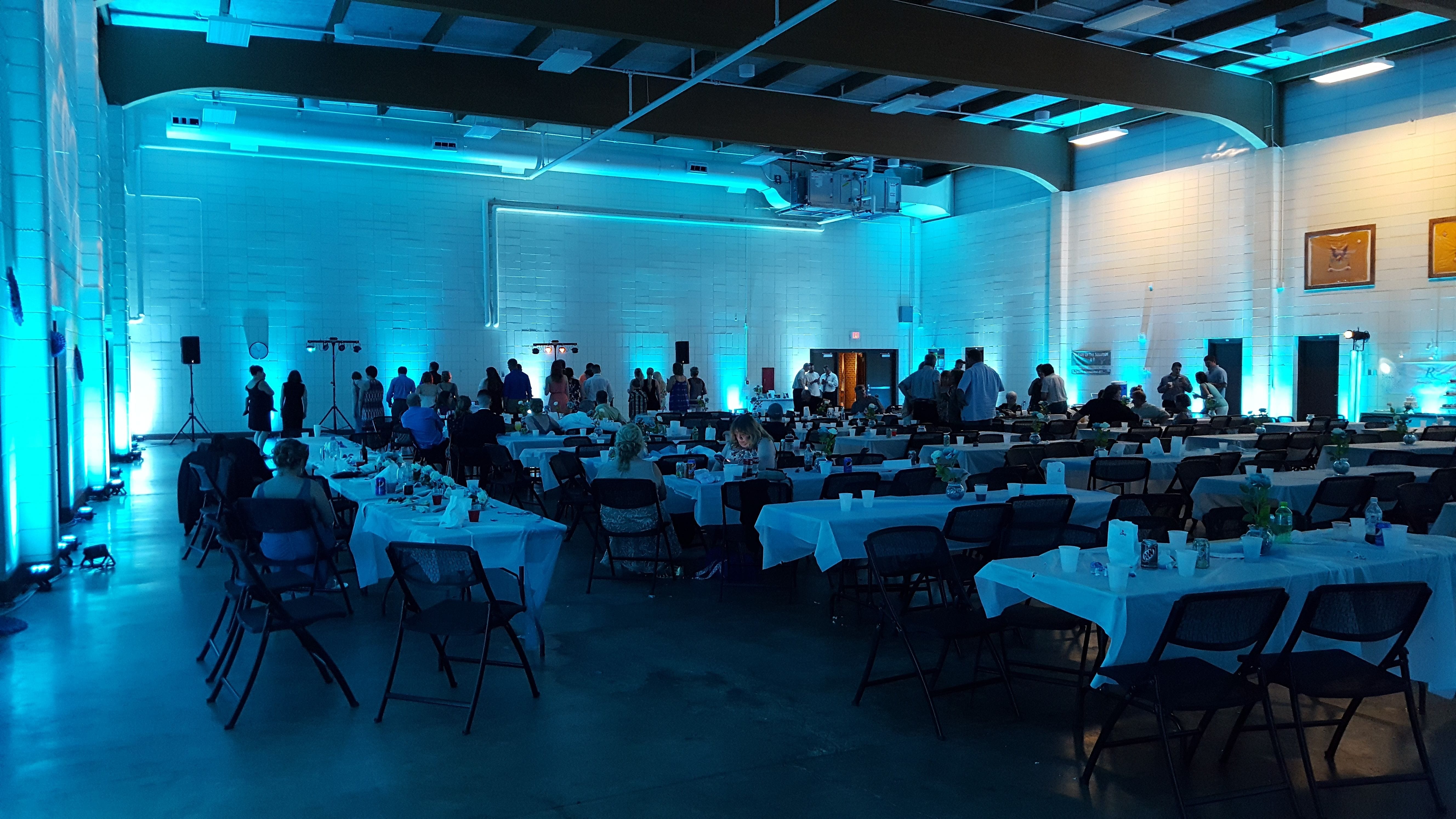 Duluth Armory wedding lighting by Duluth Event Lighting. Up lighting in teal.