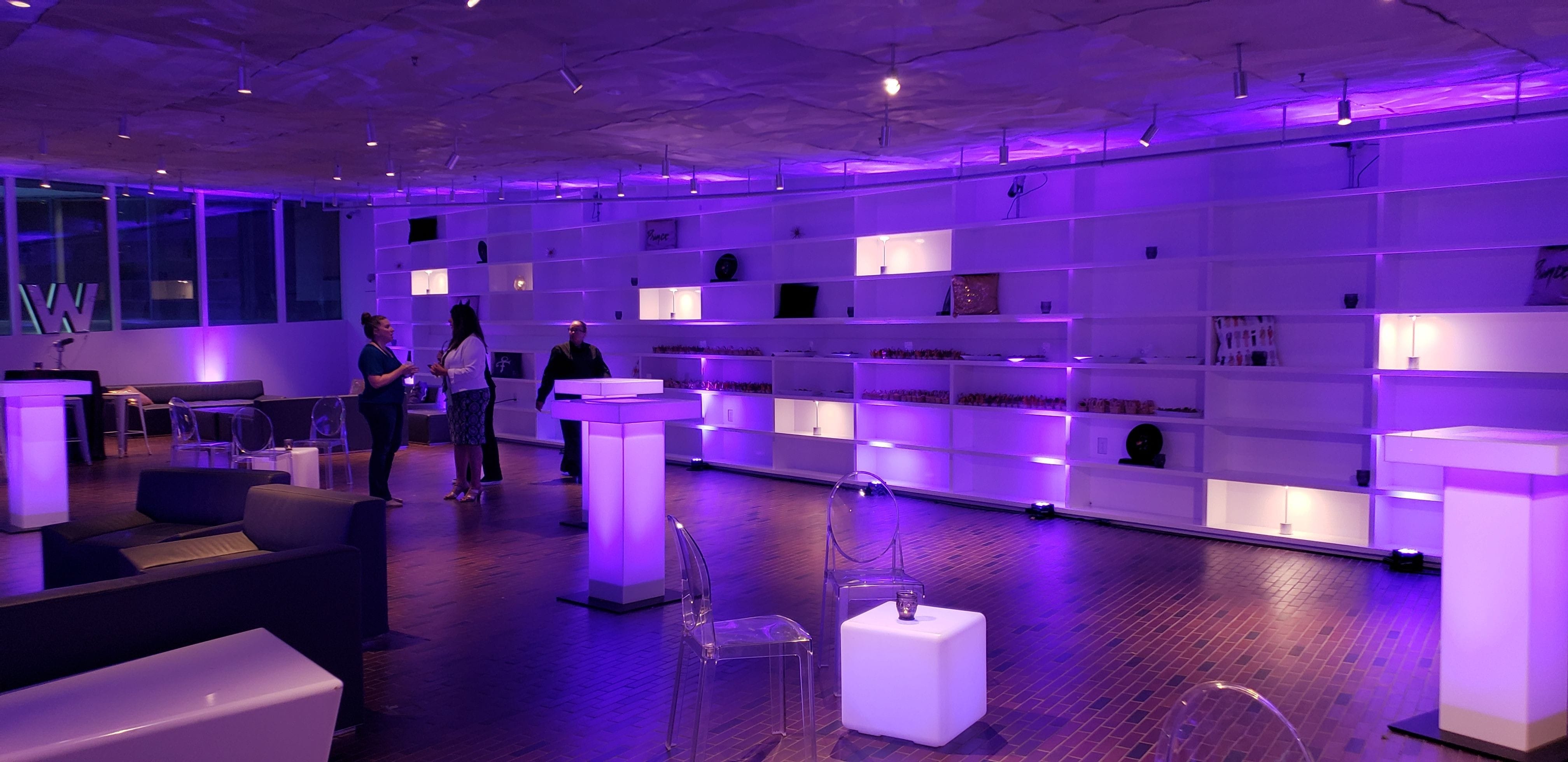 Walker Art Center event lighting with glowing cocktail tables in purple.