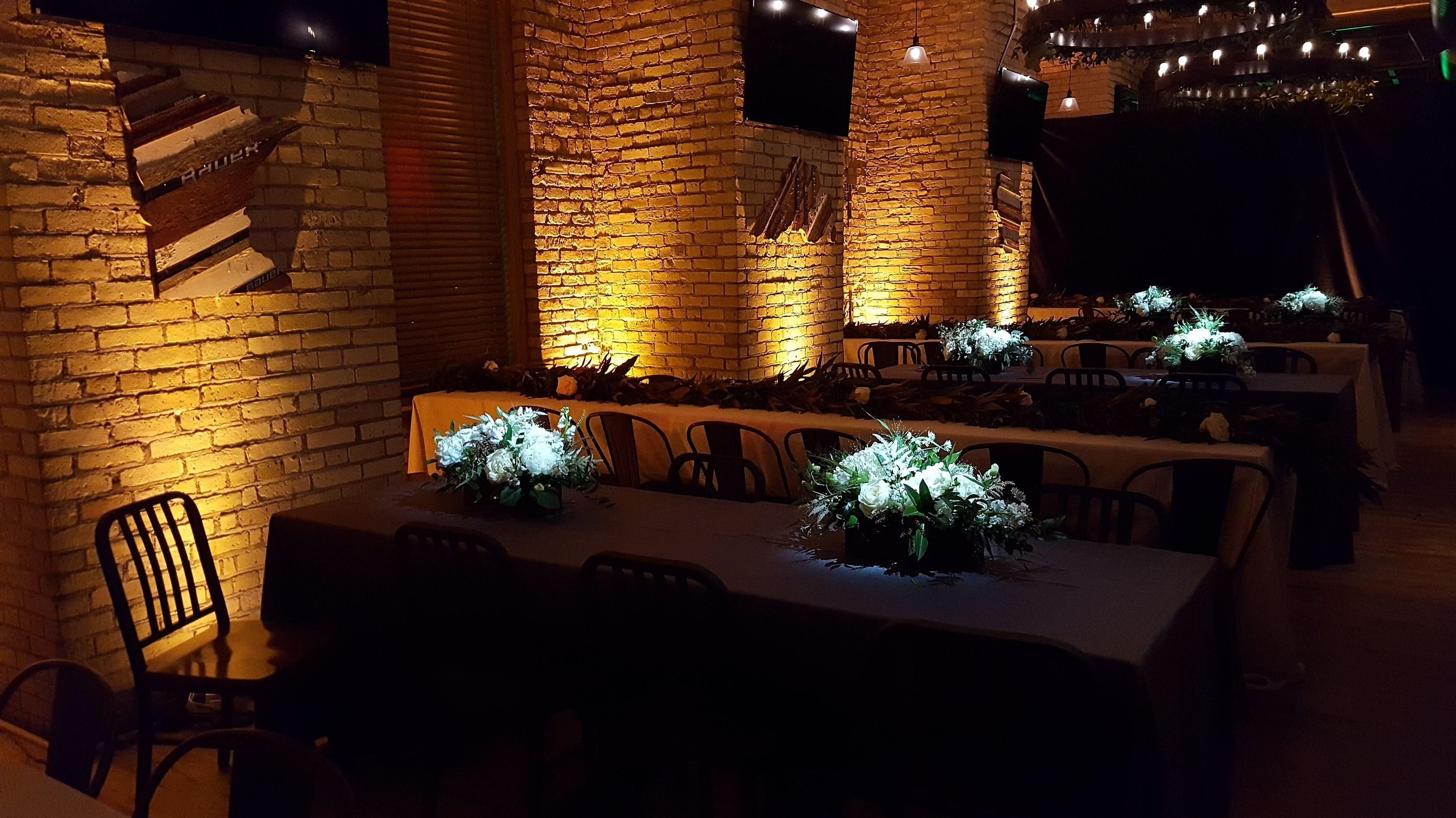 Wedding lighting at Hoops Brewery with pin spots on the flowers.