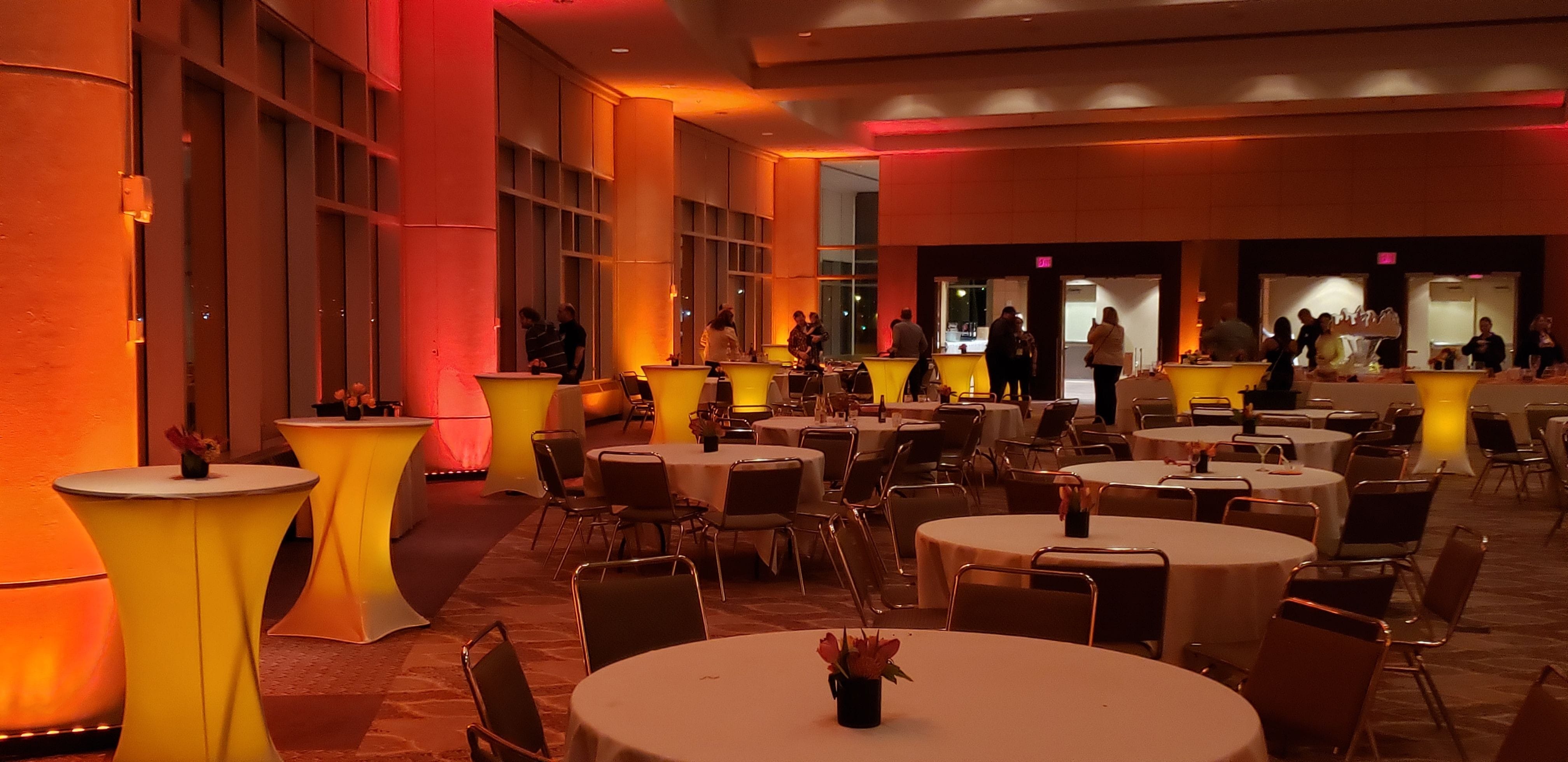 Upper Lakes Foods Dinner at Harbor side Ballroom with amber cocktail tables and orange up lighting.