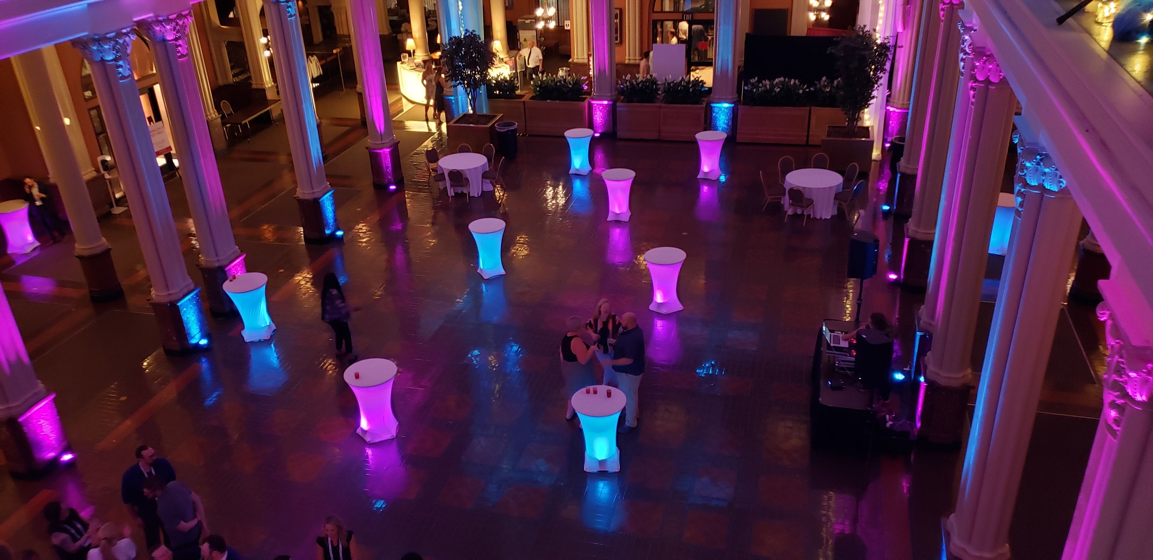 Event lighting at the Landmark Center in St. Paul with glowing cocktail tables.