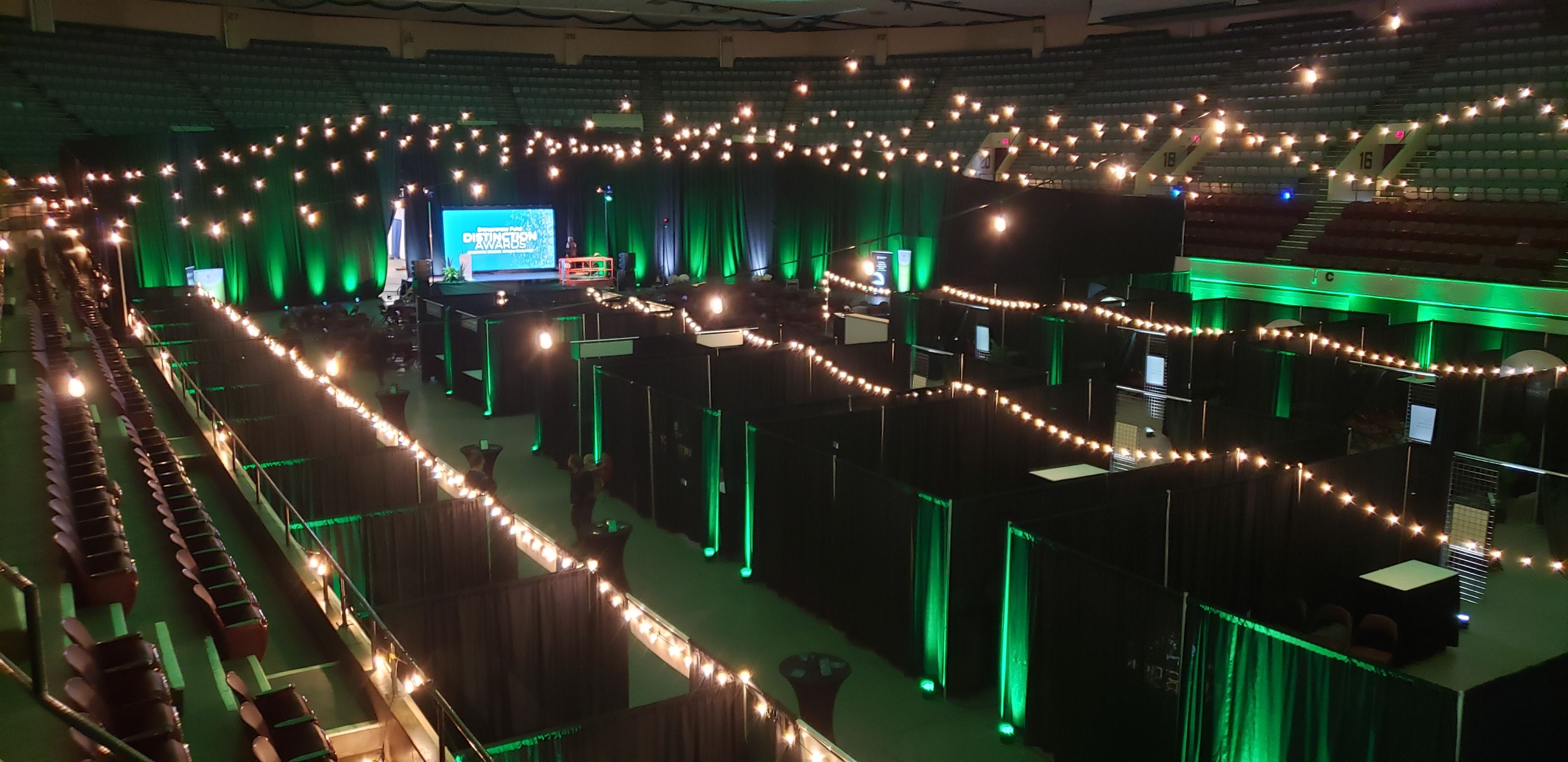 A garden feel for a conference at the DECC on the arena floor. Up lighting in green with bistro in the air
