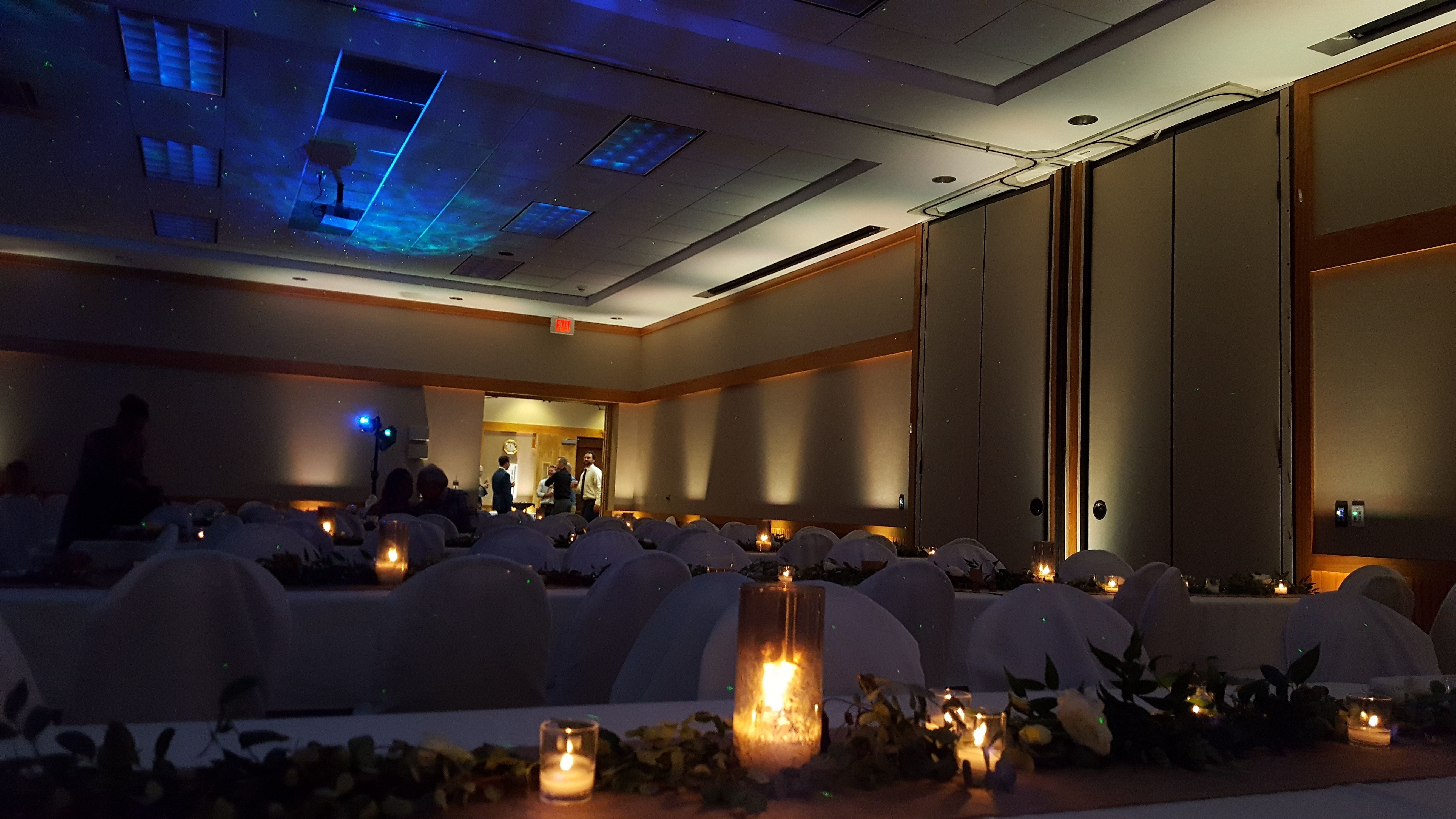 Wedding lighting in warm white with a Northern Lights on the ceiling. Lower level room.