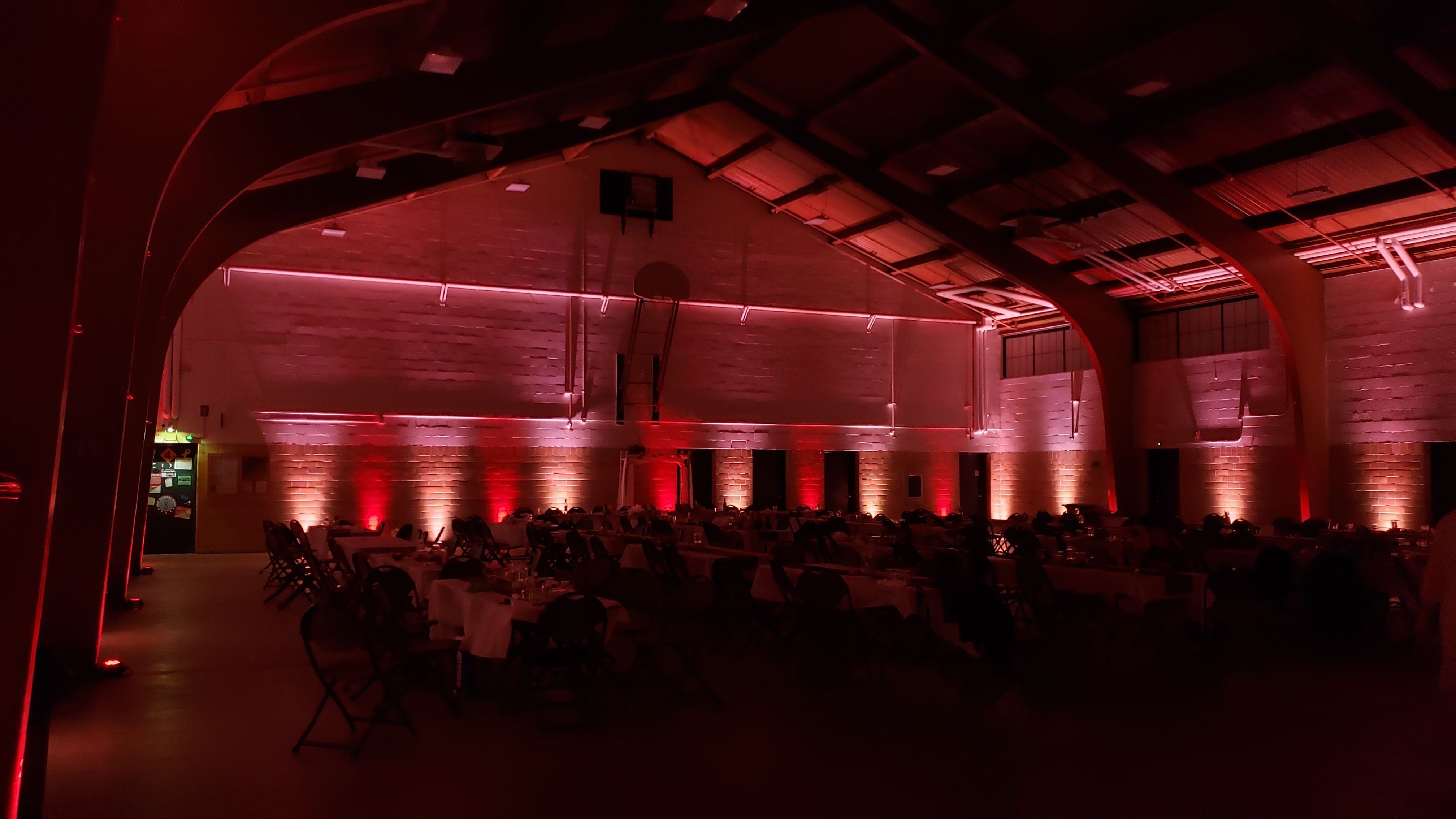 Wedding lighting at the Cloquet Armory by Duluth Event Lighting. Up lighting in blush pink and red.