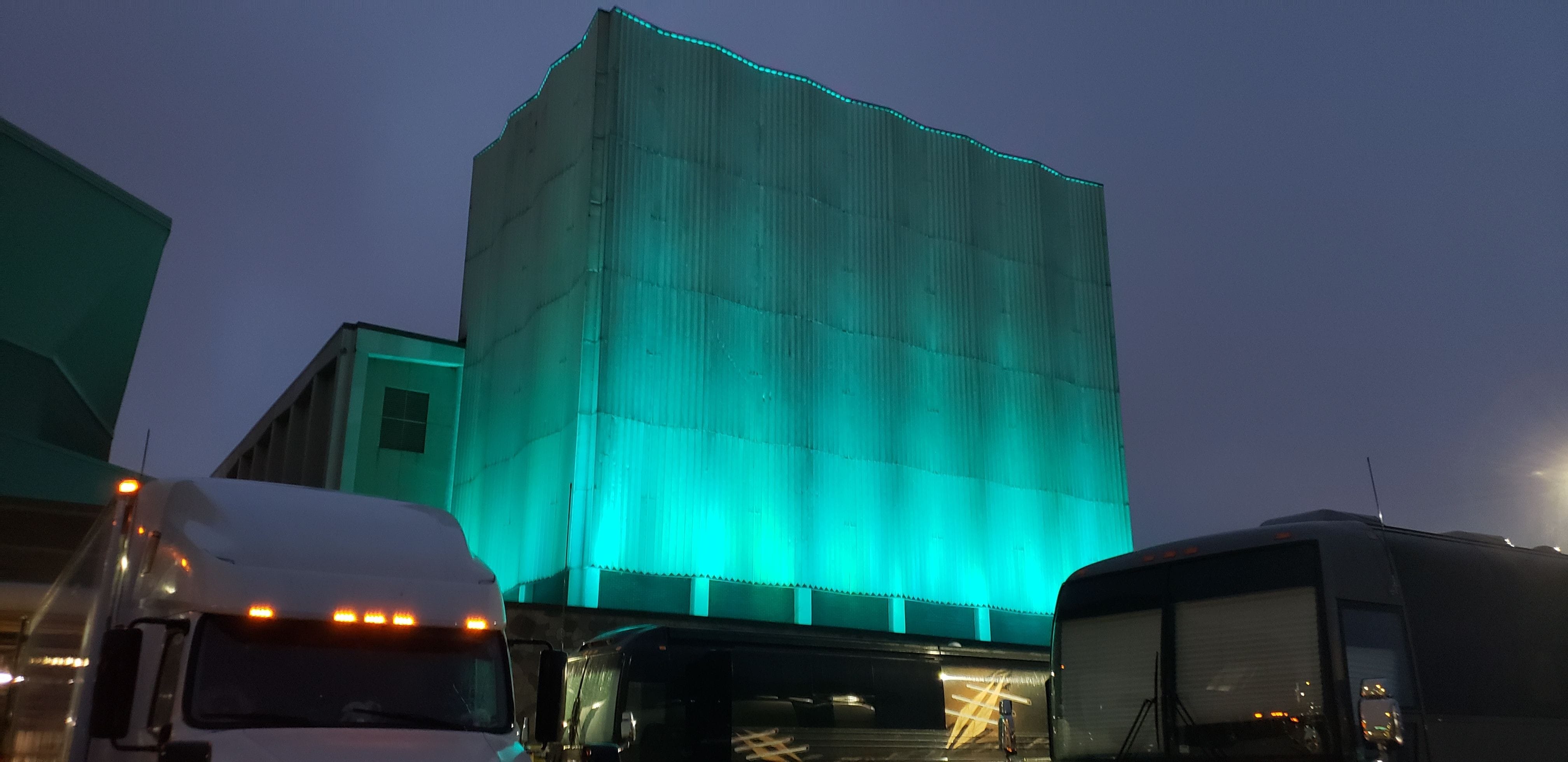 The DECC theater flyloft lit in teal for Turn Duluth Teal 2023 by Duluth Event Lighting