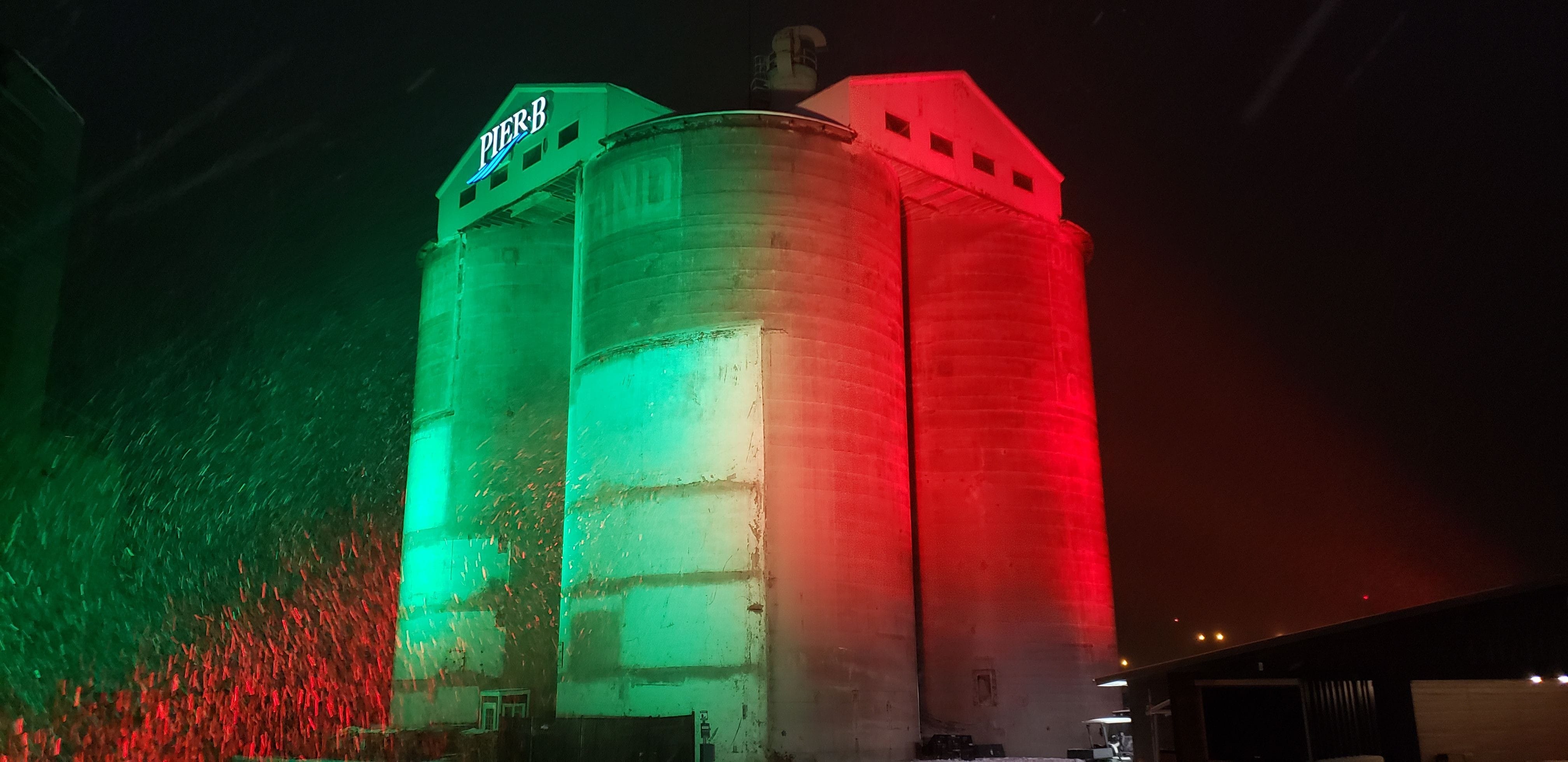 Pier B silos lit in red and green for holiday lighting by Duluth Event Lighting