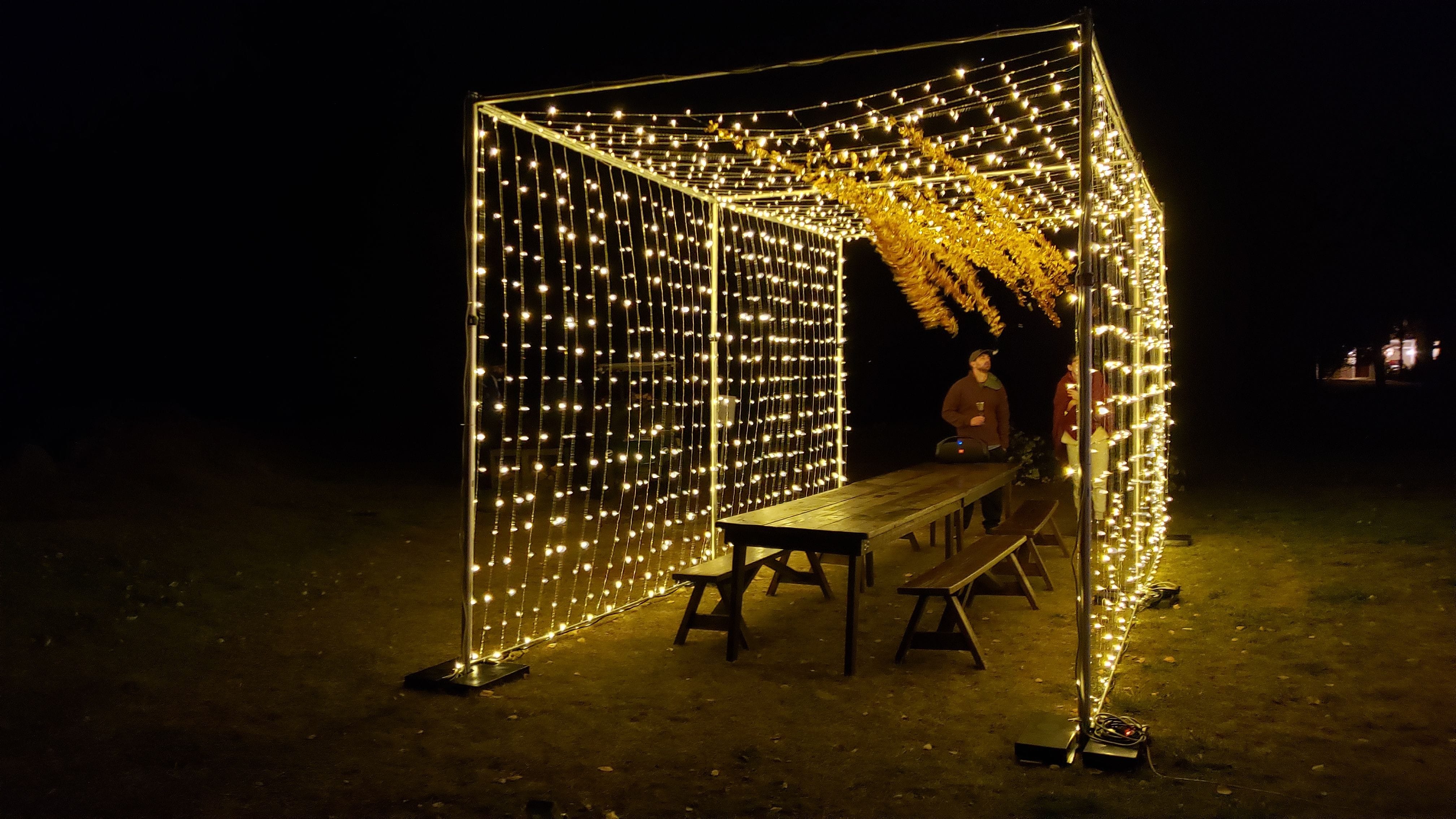 Tent wedding lighting. a LED Light curtain structure over a table.