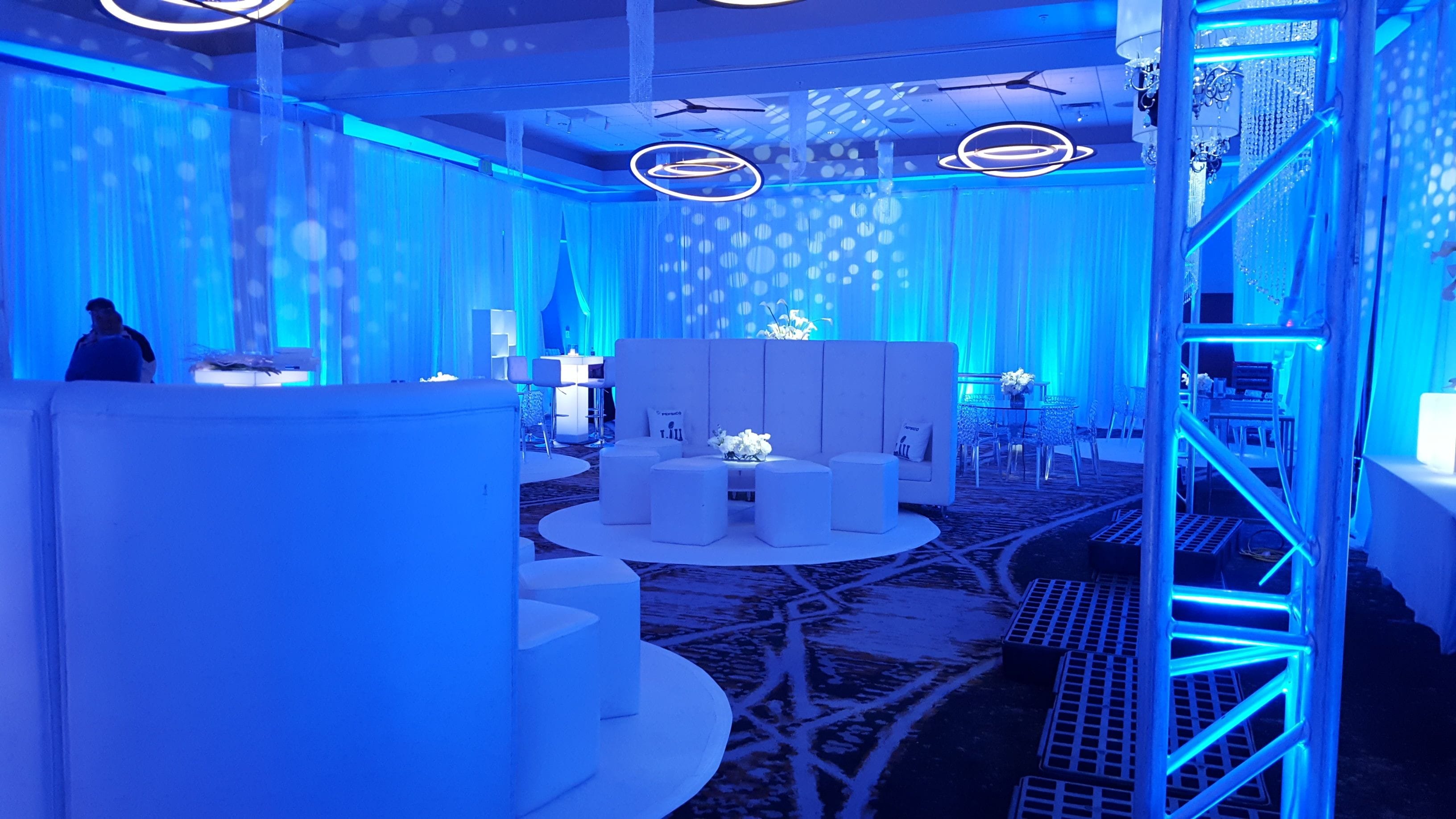 Blue up lighting with glowing cocktail tables, pin spots and gobos for a pre Super Bowl party at the Minneapolis Renaissance Depot Hotel.