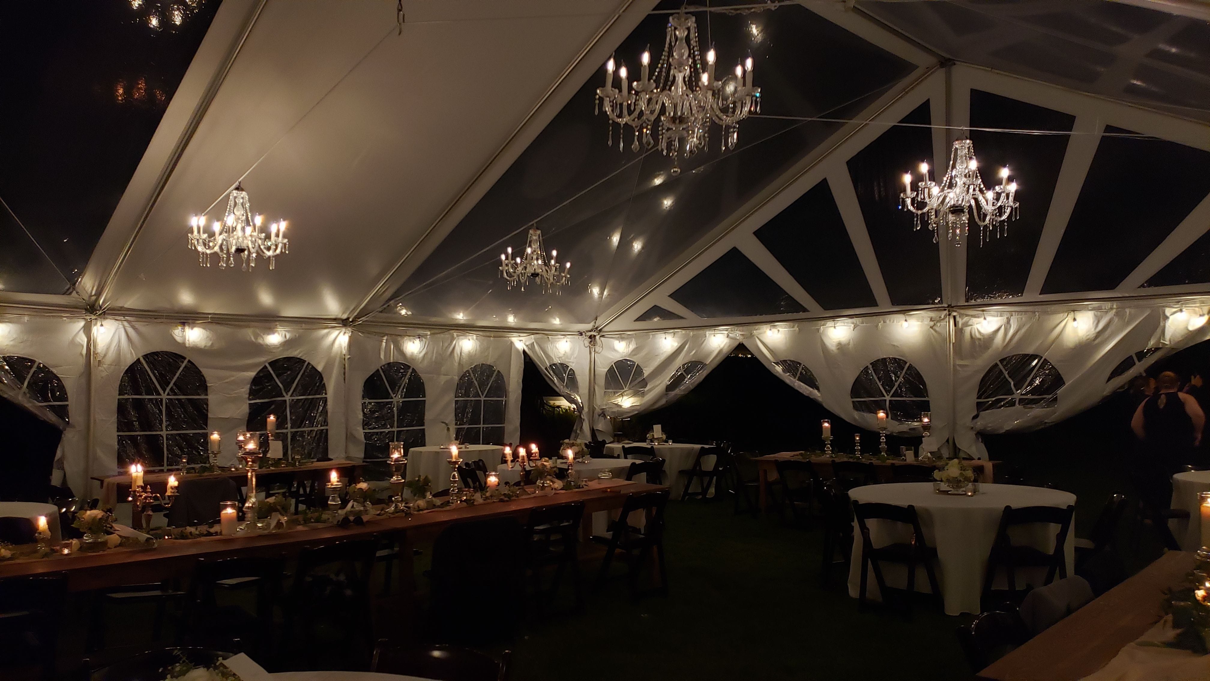 Wedding lighting in a tent by Duluth Event Lighting. Four chandeliers and bistro.