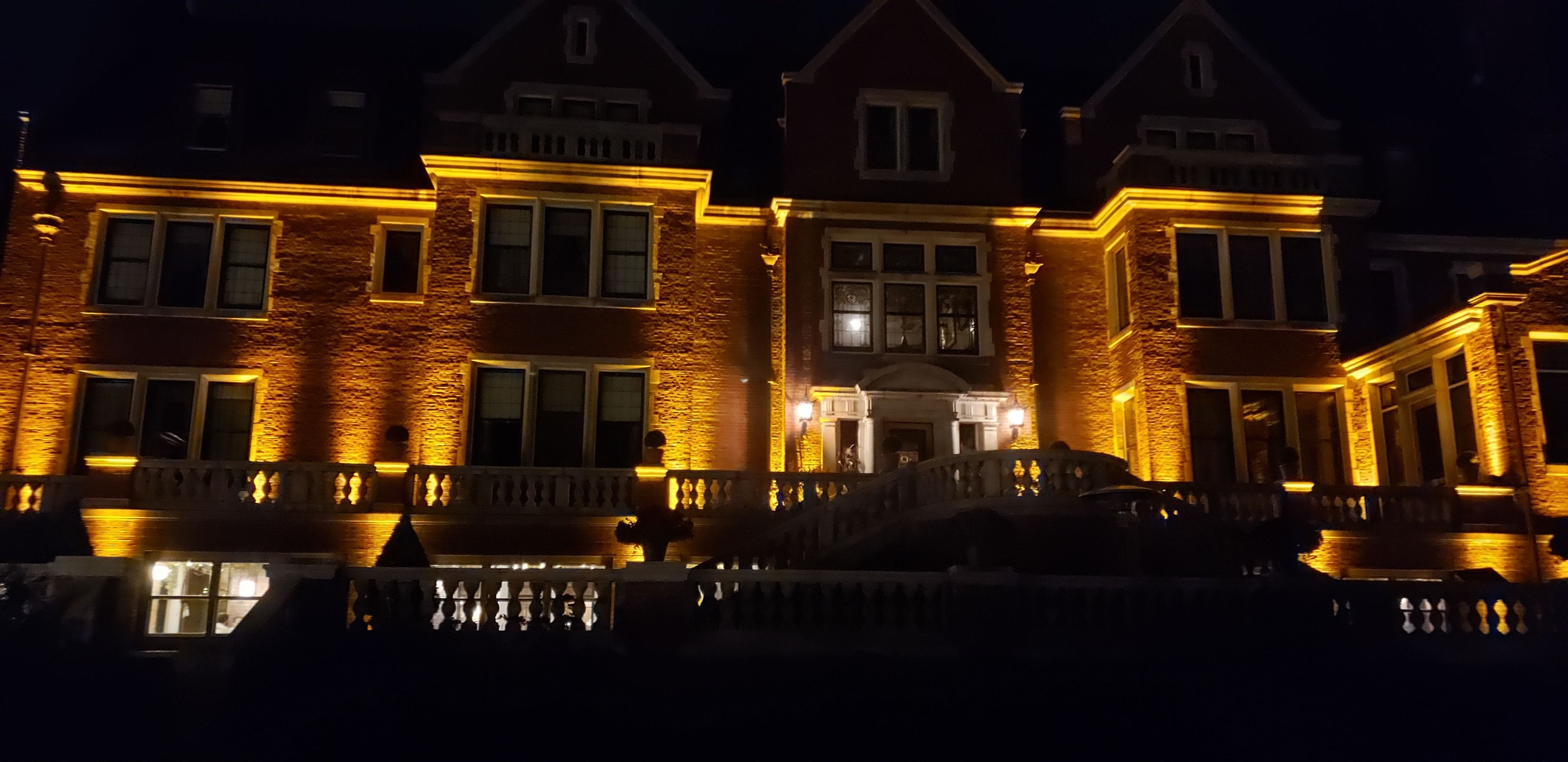 Outdoor up lighting in amber on the back of the Glensheen mansion